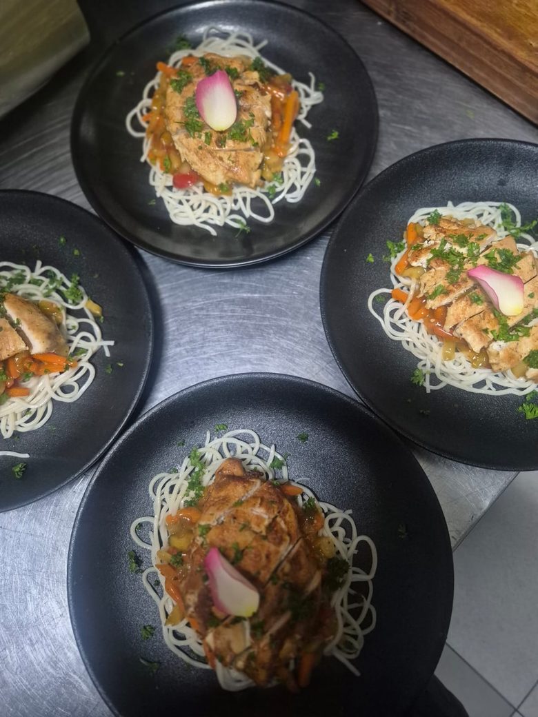 Rows of plated pasta mains ready for service by King Protea Services